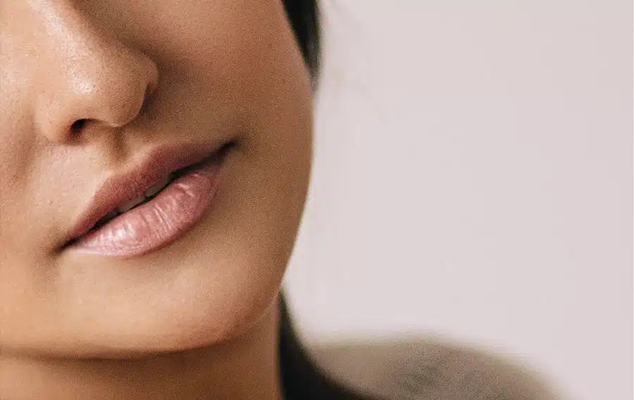 Close-up of a woman's lower face highlighting the contoured cheek area post buccal fat removal.