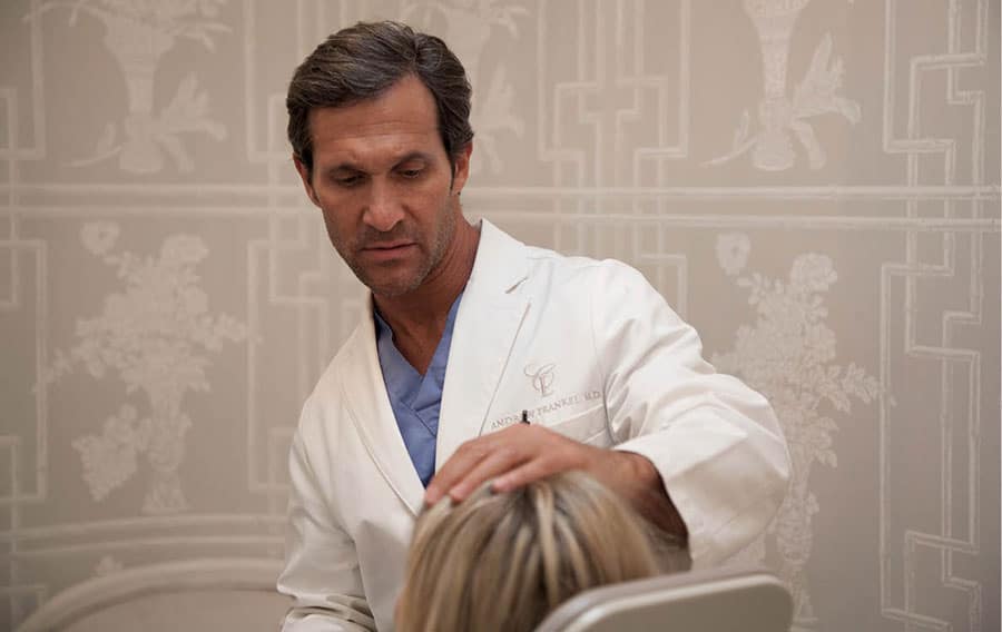 Dr. Frankel examines a patient in relation to aesthetic neck surgery.