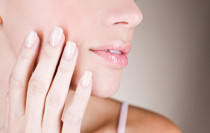 Close-up of a woman’s lower face highlighting smooth skin and defined jawline after non-surgical enhancement