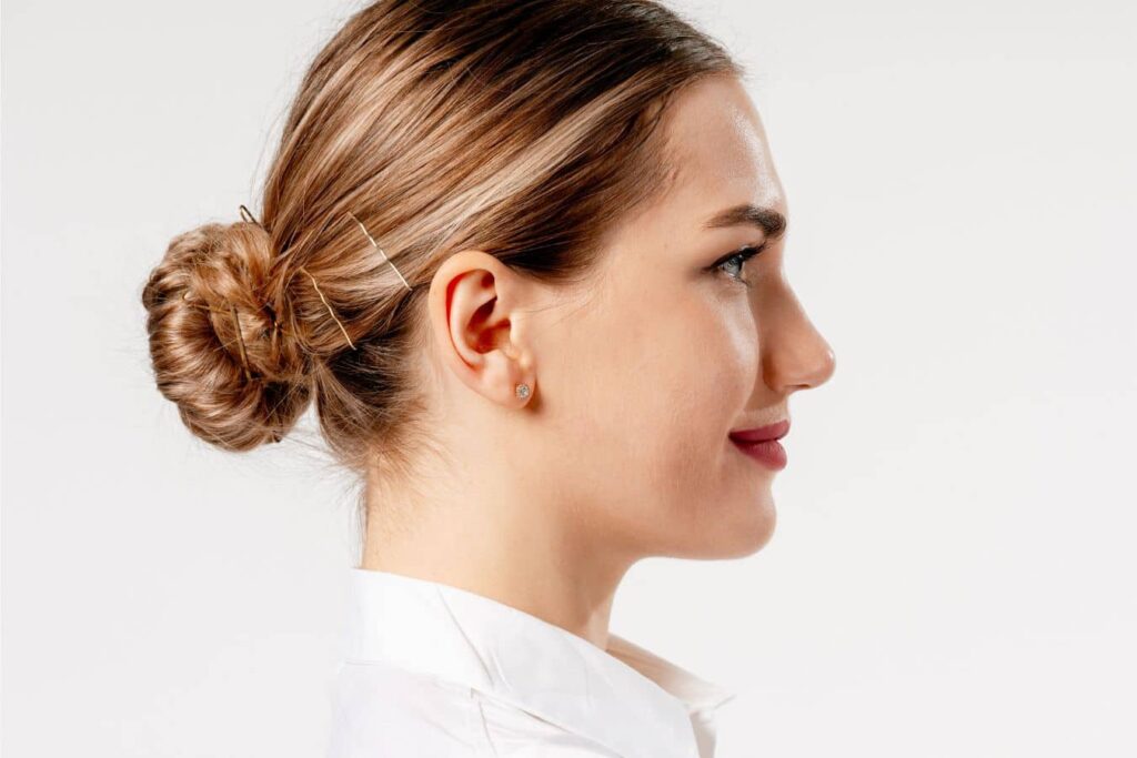 Side profile of a woman highlighting healing and swelling care after revision rhinoplasty